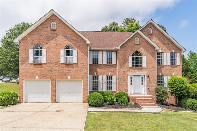 1241 Hogan Ridge Ct, Grayson, GA 30017 - colonial-style house featuring concrete driveway, brick siding, a garage, and a front yard