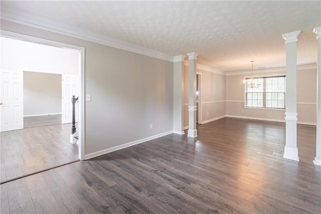 1241 Hogan Ridge Ct, Grayson, GA 30017 - spare room featuring decorative columns, a chandelier, dark wood finished floors, baseboards, and ornamental molding