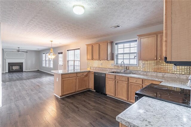 1241 Hogan Ridge Ct, Grayson, GA 30017 - kitchen featuring dishwasher, a sink, a peninsula, light countertops, and dark wood-type flooring