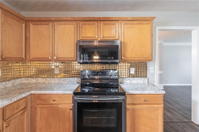 1241 Hogan Ridge Ct, Grayson, GA 30017 - kitchen with electric stove, stainless steel microwave, dark wood finished floors, backsplash, and light stone counters
