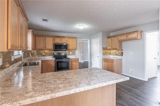 1241 Hogan Ridge Ct, Grayson, GA 30017 - kitchen with electric range, a sink, light countertops, a peninsula, and a textured ceiling