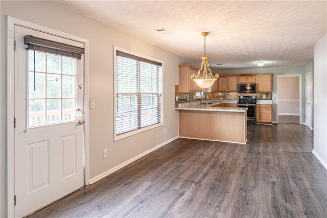 1241 Hogan Ridge Ct, Grayson, GA 30017 - kitchen featuring stainless steel microwave, electric range, a textured ceiling, a peninsula, and baseboards
