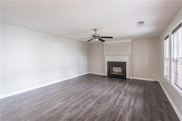 1241 Hogan Ridge Ct, Grayson, GA 30017 - unfurnished living room with a ceiling fan, dark wood finished floors, a large fireplace, a textured ceiling, and baseboards