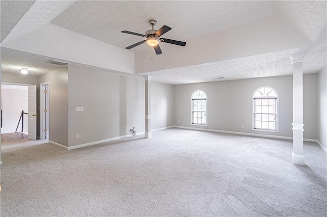 1241 Hogan Ridge Ct, Grayson, GA 30017 - carpeted spare room with a textured ceiling, ceiling fan, baseboards, and decorative columns