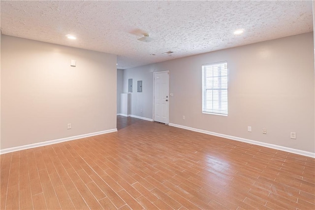 1241 Hogan Ridge Ct, Grayson, GA 30017 - empty room featuring baseboards, wood finished floors, recessed lighting, and a textured ceiling