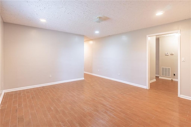 1241 Hogan Ridge Ct, Grayson, GA 30017 - unfurnished room with light wood-type flooring, baseboards, recessed lighting, and a textured ceiling