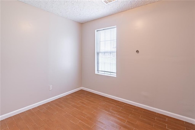 1241 Hogan Ridge Ct, Grayson, GA 30017 - spare room with baseboards, wood finished floors, and a textured ceiling