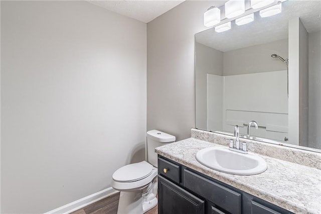 1241 Hogan Ridge Ct, Grayson, GA 30017 - full bathroom featuring wood finished floors, vanity, toilet, baseboards, and a shower