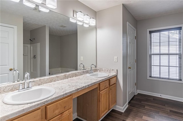 1241 Hogan Ridge Ct, Grayson, GA 30017 - full bathroom with wood finished floors, double vanity, baseboards, and a closet