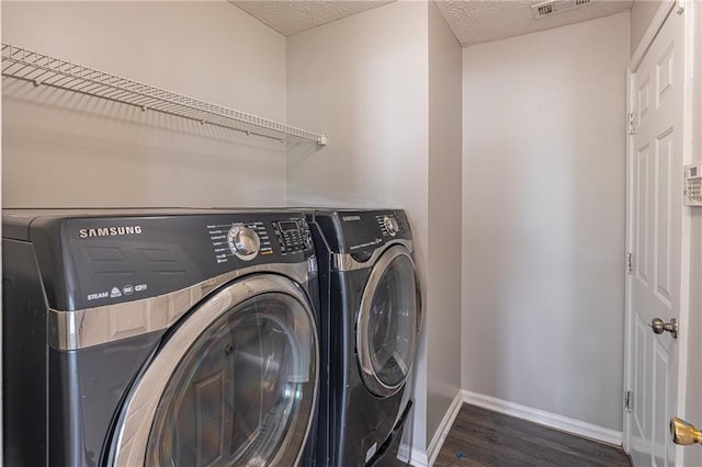 1241 Hogan Ridge Ct, Grayson, GA 30017 - laundry area with wood finished floors, baseboards, washer and clothes dryer, and a textured ceiling