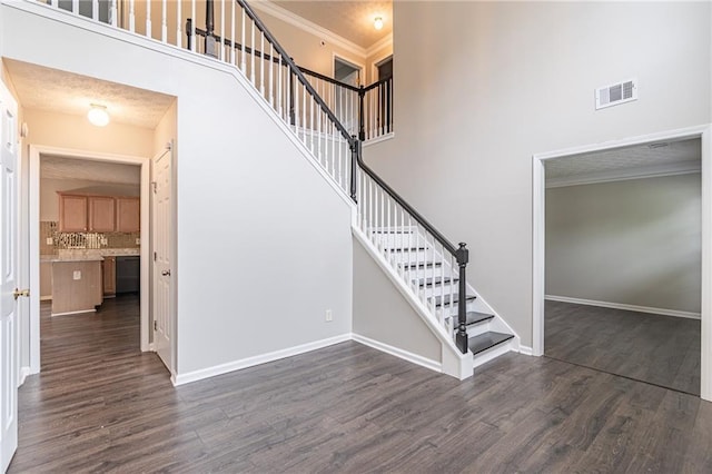 1241 Hogan Ridge Ct, Grayson, GA 30017 - stairs featuring a high ceiling, wood finished floors, baseboards, and ornamental molding