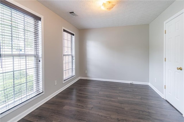 1241 Hogan Ridge Ct, Grayson, GA 30017 - unfurnished room featuring a textured ceiling, dark wood finished floors, and baseboards