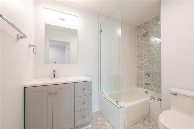 full bathroom featuring vanity, toilet, and tiled shower / bath