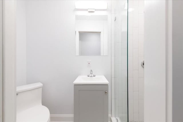 bathroom with vanity, toilet, and a shower with shower door