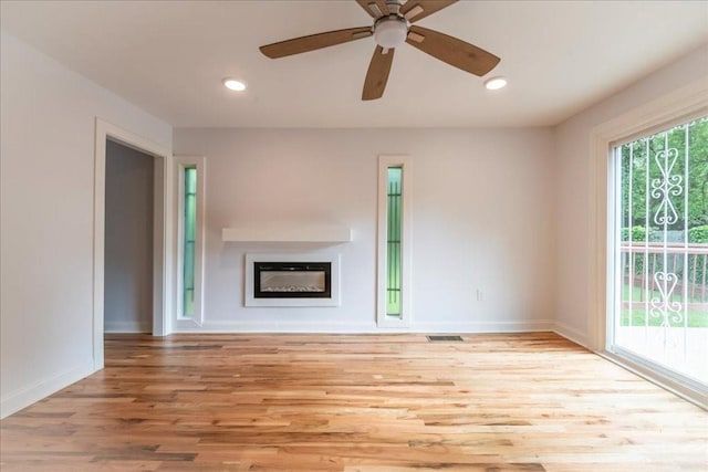 unfurnished living room featuring light hardwood / wood-style floors and ceiling fan