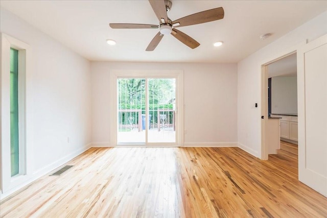 spare room featuring ceiling fan and light wood-type flooring