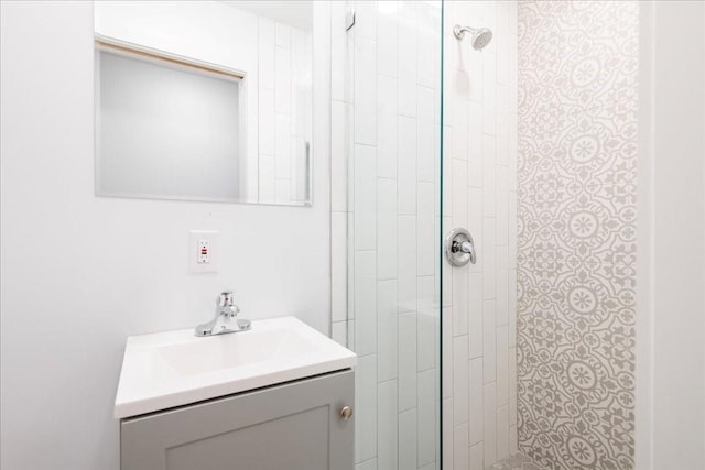 bathroom featuring vanity and tiled shower