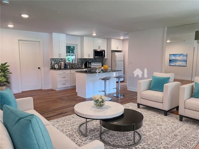 living room with sink and light hardwood / wood-style floors