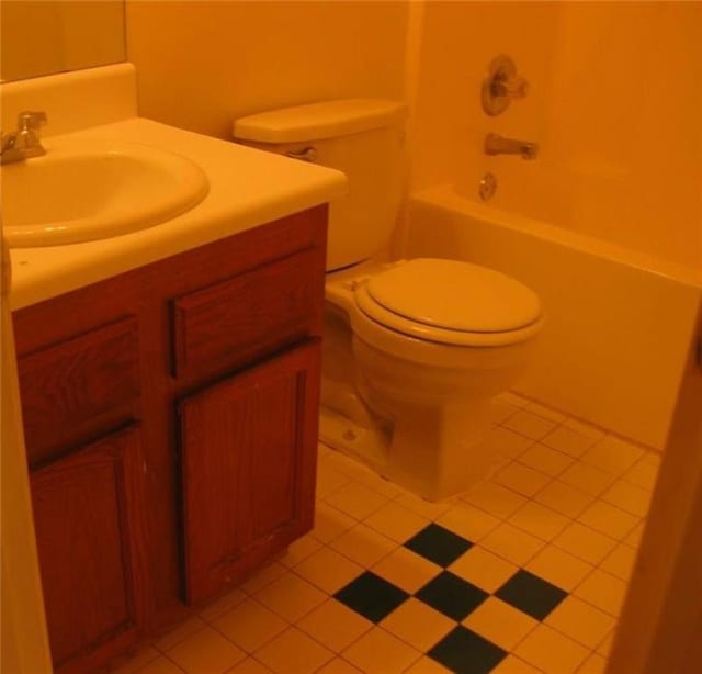 full bathroom featuring toilet, tile patterned floors, bathing tub / shower combination, and vanity