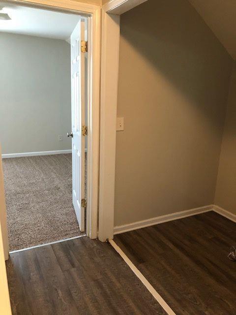 corridor with dark wood-type flooring