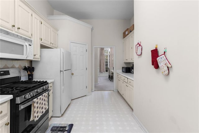 kitchen featuring white appliances, tasteful backsplash, and white cabinetry