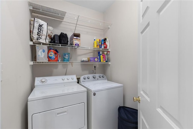 washroom with washing machine and clothes dryer