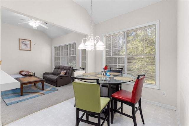 carpeted dining room with vaulted ceiling and ceiling fan with notable chandelier