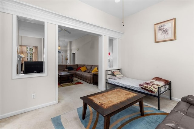 carpeted living room with ceiling fan