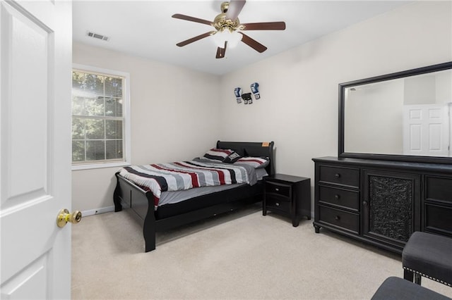 bedroom featuring light colored carpet and ceiling fan