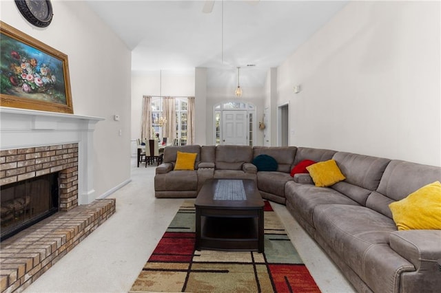 carpeted living room featuring a brick fireplace