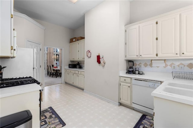 kitchen featuring white appliances, white cabinetry, and decorative backsplash