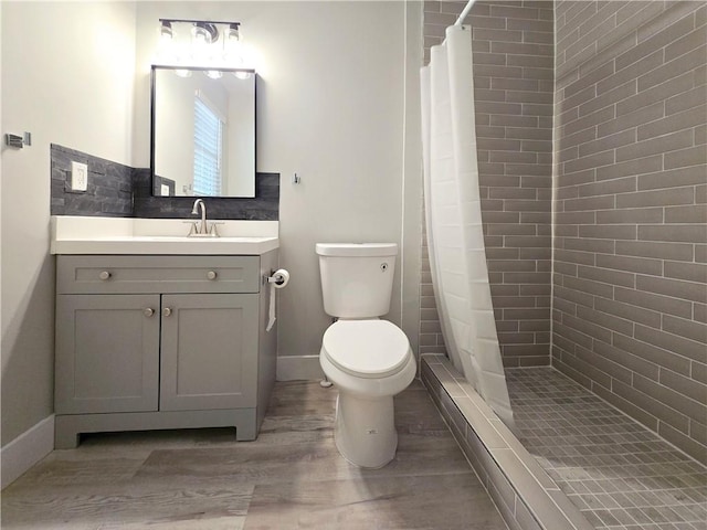 bathroom featuring vanity, a shower with curtain, toilet, and hardwood / wood-style flooring