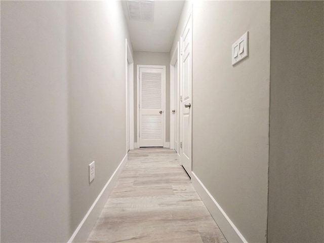 corridor with light wood-type flooring