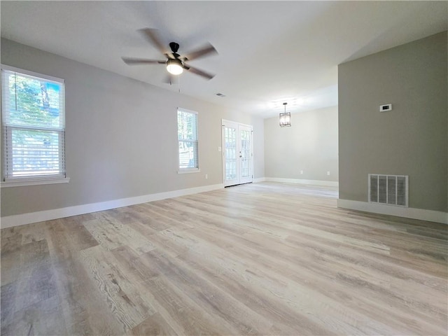 spare room with french doors, ceiling fan, and light hardwood / wood-style flooring