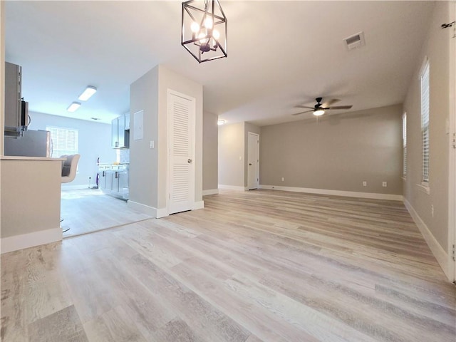 unfurnished living room with ceiling fan and light hardwood / wood-style flooring