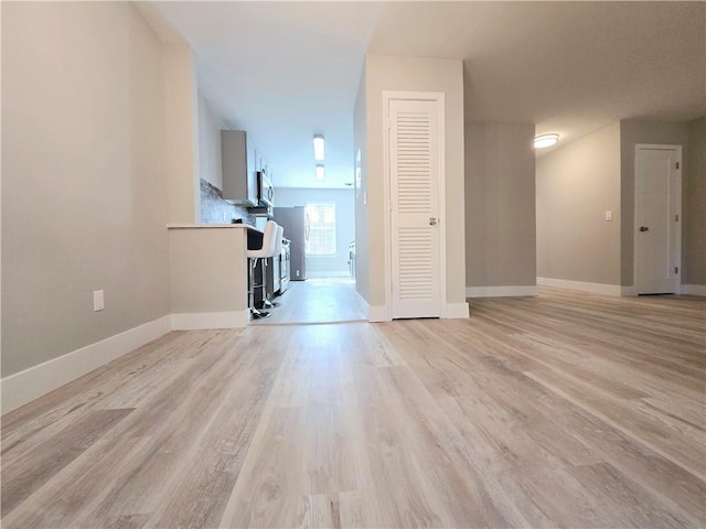 unfurnished living room with light wood-type flooring