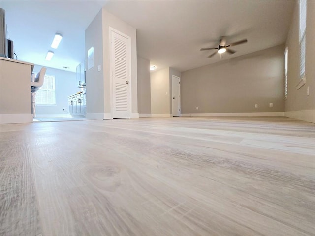 unfurnished living room featuring ceiling fan