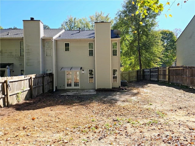 back of house featuring french doors and central air condition unit