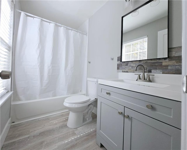 full bathroom with toilet, wood-type flooring, vanity, shower / bathtub combination with curtain, and decorative backsplash