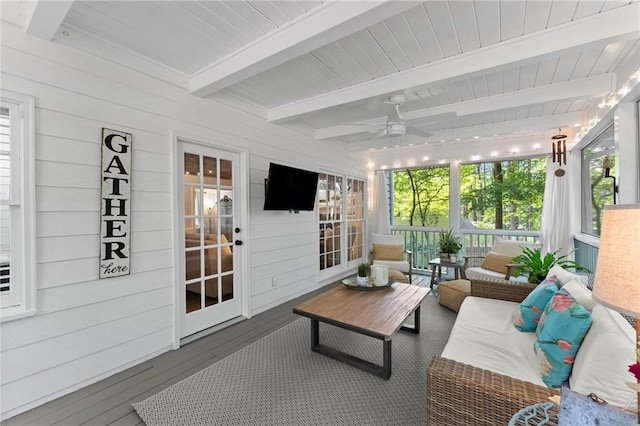 sunroom featuring an outdoor living space, a ceiling fan, beamed ceiling, and a wealth of natural light
