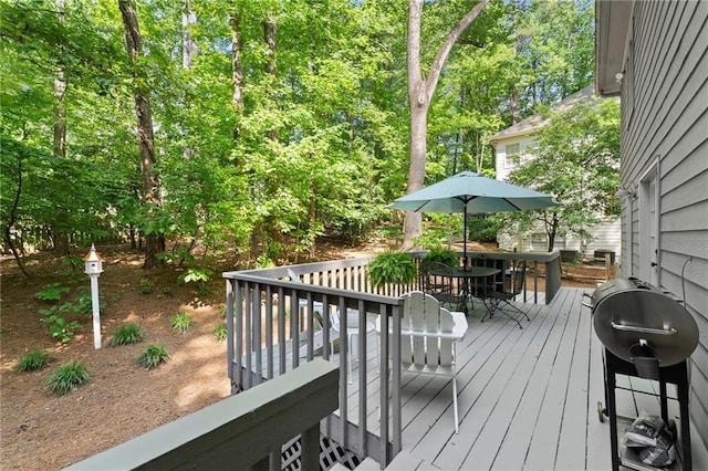 wooden terrace featuring outdoor dining area