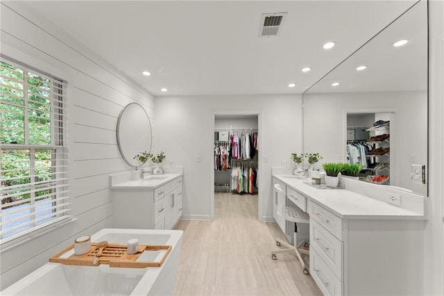 bathroom with recessed lighting, a sink, and visible vents