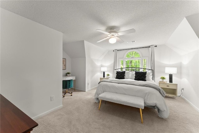 carpeted bedroom featuring baseboards, a ceiling fan, vaulted ceiling, and visible vents