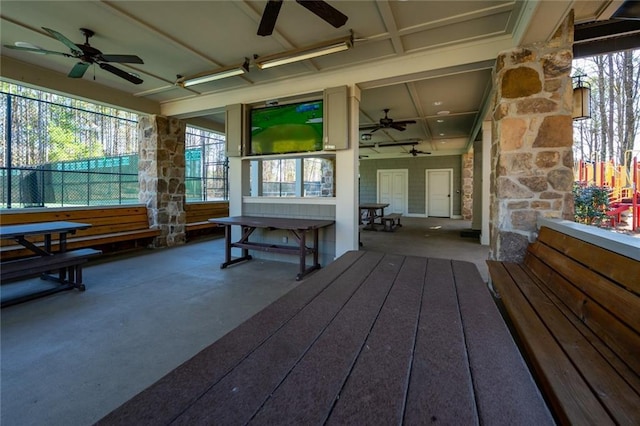 exterior space with ceiling fan and fence