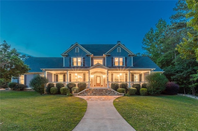 view of front of home with a lawn and covered porch