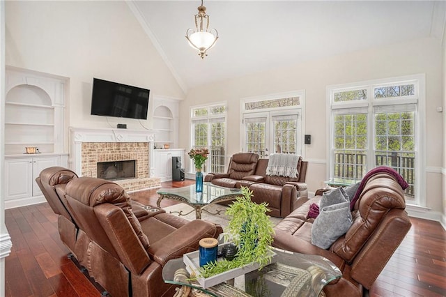 living area featuring high vaulted ceiling, a fireplace, dark wood-type flooring, and built in features