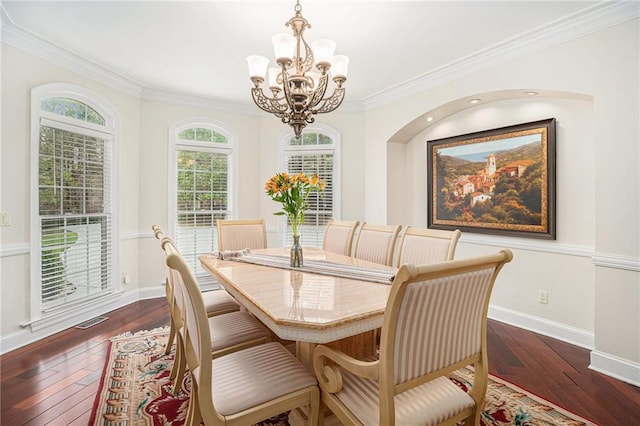 dining space with a chandelier, baseboards, visible vents, and hardwood / wood-style flooring