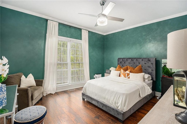 bedroom with ceiling fan, wood-type flooring, ornamental molding, and baseboards