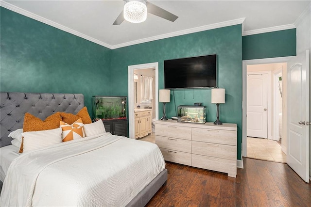 bedroom with connected bathroom, crown molding, a ceiling fan, and dark wood finished floors