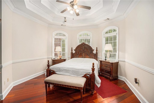 bedroom with a raised ceiling, baseboards, visible vents, and hardwood / wood-style flooring